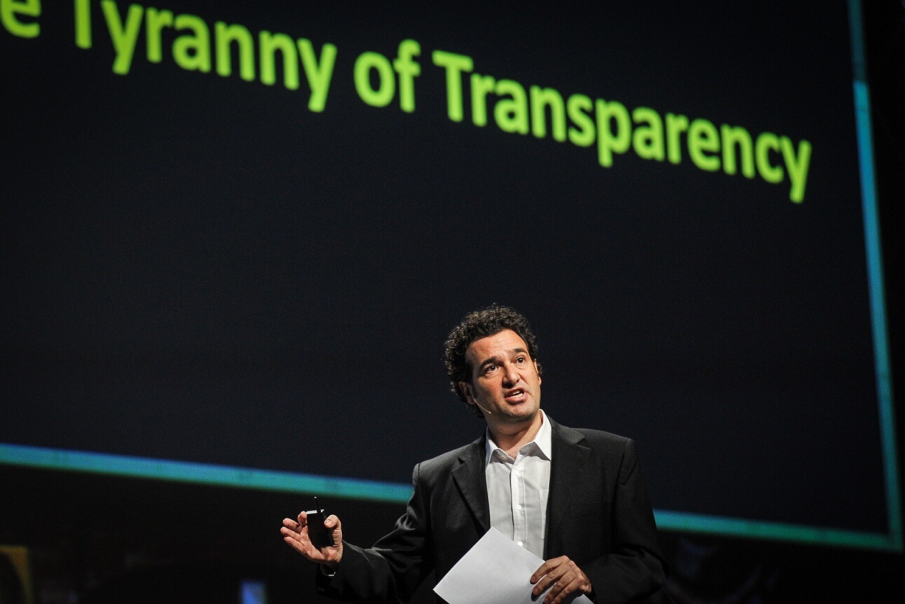 Daniel Levine on stage at a business conference talking about innovation and transparency